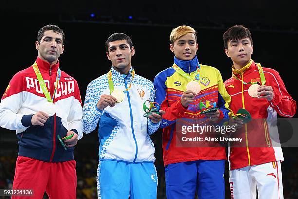 Silver medalist Misha Aloian of Russia, gold medalist Shakhobidin Zoirov of Uzbekistan and bronze medalists Yoel Segundo Finol of Venezuela and...