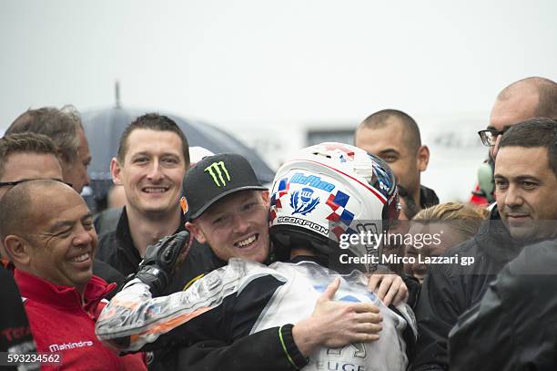 Bradley Smith of Great Britain and Monster Yamaha Tech 3 congratulates with John McPhee of Great Britain and Peugeot Saxoprint MC for the victory...