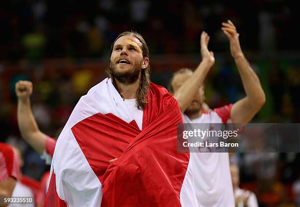 Mikkel Hansen of Denmark celebrates defeating France 28-26 to win the gold medal in Men's Handball on Day 16 of the Rio 2016 Olympic Games at Future...