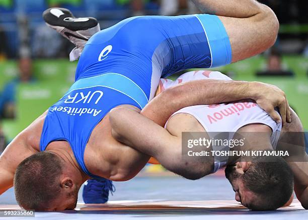 Uzbekistan's Magomed Idrisovitch Ibragimov wrestles with Ukraine's Valerii Andriitsev in their men's 97kg freestyle bronze medal match on August 21...