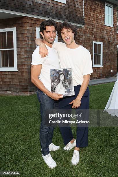 Models Akin Akman and Miles McMillan attend Daily Front Row's "Luxury and Love" party at Inn at Windmill Lane on August 20, 2016 in Amagansett, New...