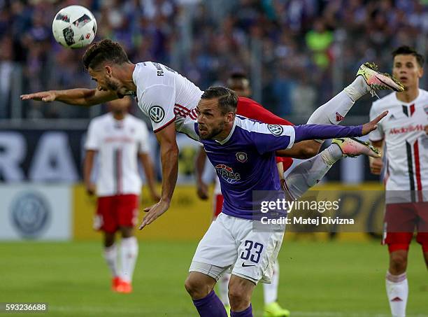 Christian Tiffert of Aue competes for the ball with Mathew Leckie of Ingolstadt during the DFB Cup match between Erzgebirge Aue and FC Ingolstadt at...