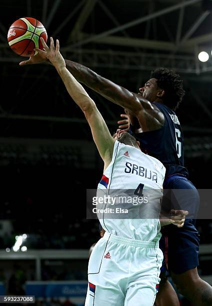 DeAndre Jordan of United States blocks a shot by Milos Teodosic of Serbia during the Men's Gold medal game on Day 16 of the Rio 2016 Olympic Games at...