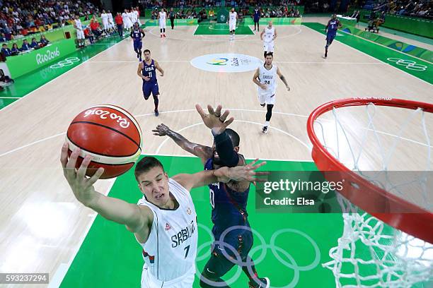 Bogdan Bogdanovic of Serbia makes a layup around Kyrie Irving of United States during the Men's Gold medal game on Day 16 of the Rio 2016 Olympic...