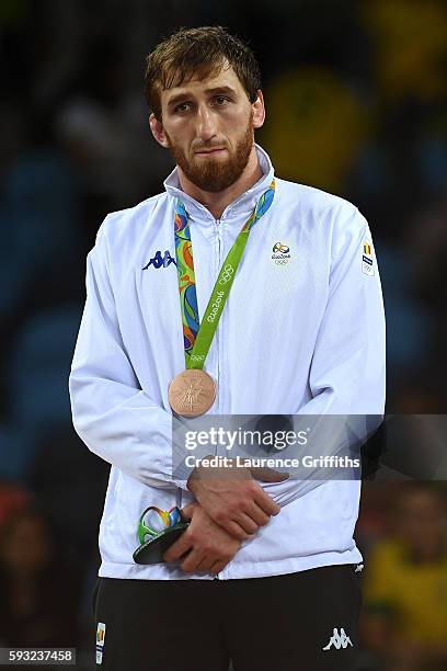 Bronze medalist Albert Saritov of Romania stands on the podium during the medal ceremony for the Men's Freestyle 97kg on Day 16 of the Rio 2016...