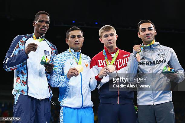 Silver medalist Lorenzo Sotomayor Collazo of Azerbaijan, gold medalist Fazliddin Gaibnazarov of Uzbekistan and bronze medalists Vitaly Dunaytsev of...