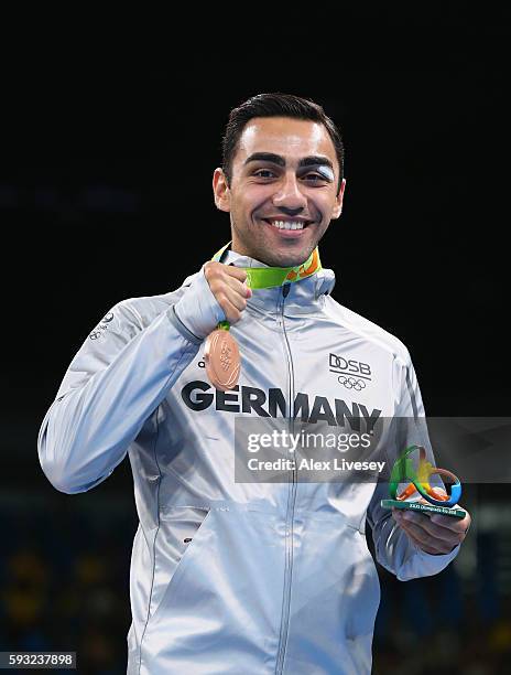 Bronze medalist Artem Harutyunyan of Germany poses on the podium during the medal ceremony for the Men's Boxing Light Welter on Day 16 of the Rio...