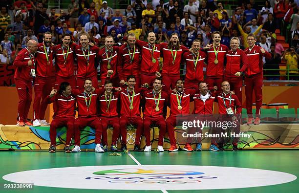 Team Denmark pose on the podium during the medal ceremony for Men's Handball after winning the gold medal on Day 16 of the Rio 2016 Olympic Games at...
