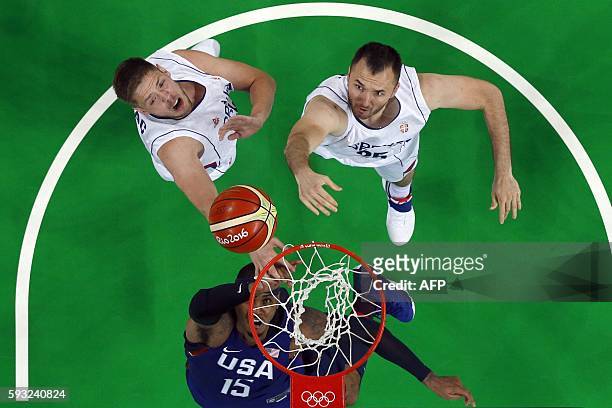 An overview shows USA's forward Carmelo Anthony Serbia's centre Vladimir Stimac and Serbia's power forward Milan Macvan eye a rebound during a Men's...