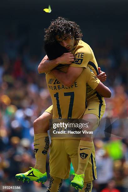 Matias Britos of Pumas celebrates with teammate Jesus Gallardo after scoring the third goal of his team during the 6th round match between Pumas UNAM...