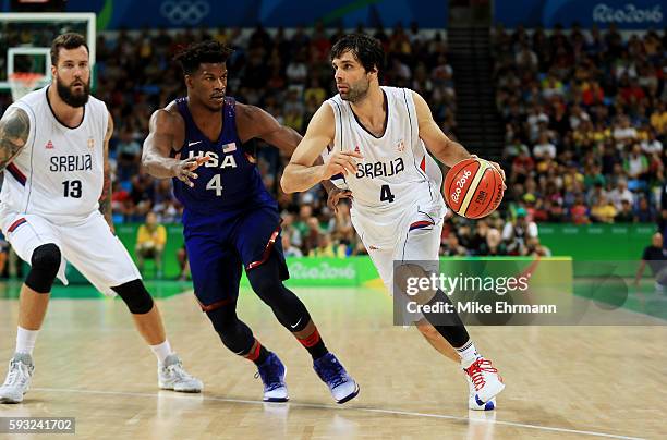 Milos Teodosic of Serbia drives the ball around Jimmy Butler of United States during the Men's Gold medal game on Day 16 of the Rio 2016 Olympic...