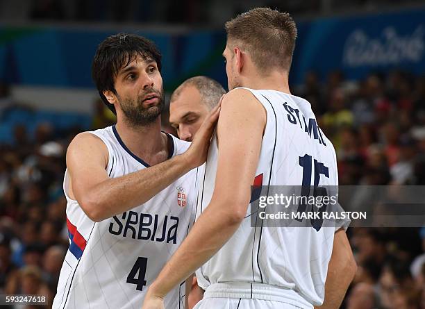 Serbia's guard Milos Teodosic speaks with Serbia's centre Vladimir Stimac during a Men's Gold medal basketball match between Serbia and USA at the...