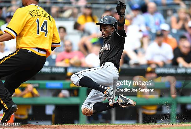 Dee Gordon of the Miami Marlins scores on after a wild pitch by Ryan Vogelsong of the Pittsburgh Pirates during the fourth inning on August 21, 2016...