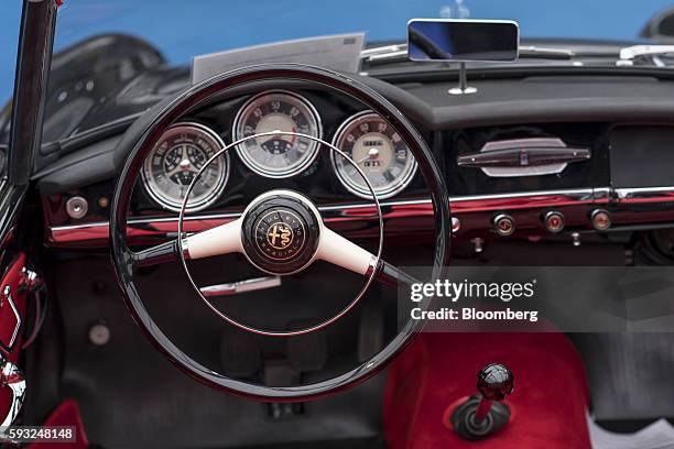 The steering wheel and interior of a 1958 Alfa Romeo Inc. Giulietta Spider Veloce vehicle is seen on display during the Gooding and Company auction...