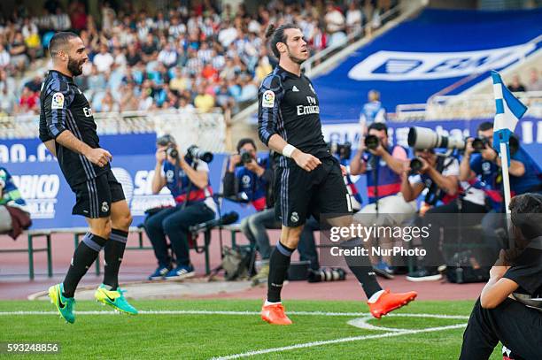 Bale of Real Madrid celebrates with teammates after scoring during the Spanish league football match between Real Sociedad and Real Madrid at the...