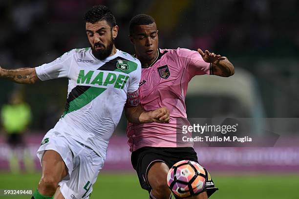 Francesco Magnanelli of Sassuolo and Robin Quaison of Palermo compete for the ball during the Serie A match between US Citta di Palermo and US...