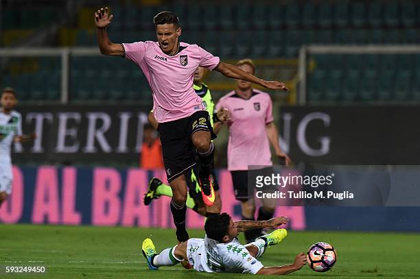 Norbert Balogh of Palermo jumps as Stefano Sensi of Sassuolo tackles during the Serie A match between US Citta di Palermo and US Sassuolo at Stadio...