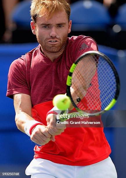 Bjorn Fratangelo of the United States returns a shot to Evgeny Donskoy of Russia during the Winston-Salem Open at Wake Forest University on August...