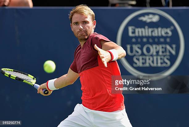 Bjorn Fratangelo of the United States returns a shot to Evgeny Donskoy of Russia during the Winston-Salem Open at Wake Forest University on August...