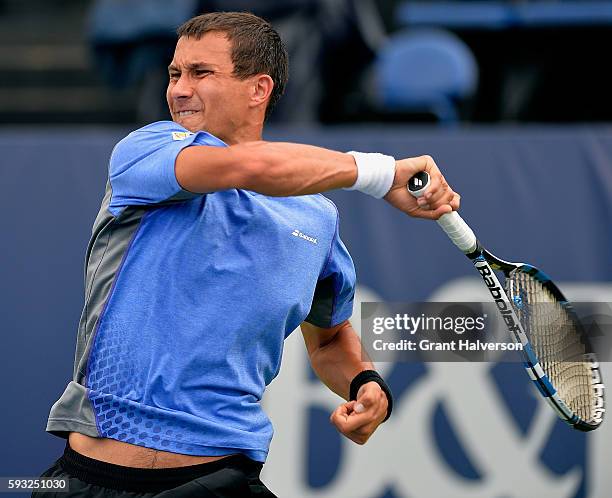 Evgeny Donskoy of Russia returns a shot to Bjorn Fratangelo of the United States during the Winston-Salem Open at Wake Forest University on August...