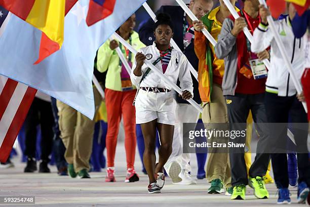 Flag bearer Simone Biles of United States walks during the "Heroes of the Games" segment during the Closing Ceremony on Day 16 of the Rio 2016...