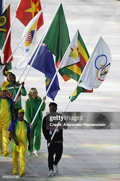 Flag bearer Popole Misenga of the Refugee Olympic Team parades in the 'Heroes of the Games' segment during the Closing Ceremony on Day 16 of the Rio...