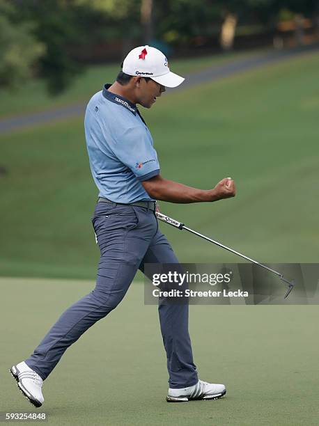 Si Woo Kim celebrates after making a putt on the 18th hole and winning the Wyndham Championsihp during the final round of the Wyndham Championship at...