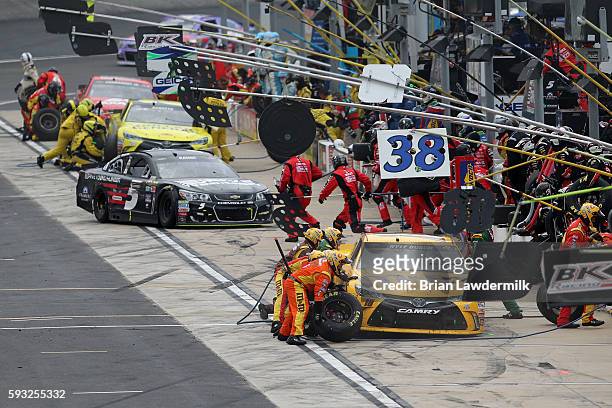 Kyle Busch, driver of the M&M's 75th Anniversary Toyota, pits during the NASCAR Sprint Cup Series Bass Pro Shops NRA Night Race at Bristol Motor...