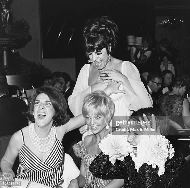Actresses Jo Anne Worley , Ruth Buzzi , Goldie Hawn and Judy Carne joking around at the after party of the Emmy Awards, 1968.