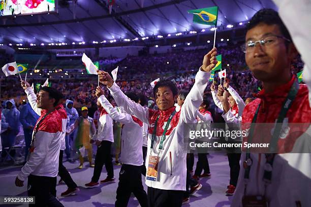 Members of Team Japan take part in the 'Heroes of the Games' segment during the Closing Ceremony on Day 16 of the Rio 2016 Olympic Games at Maracana...