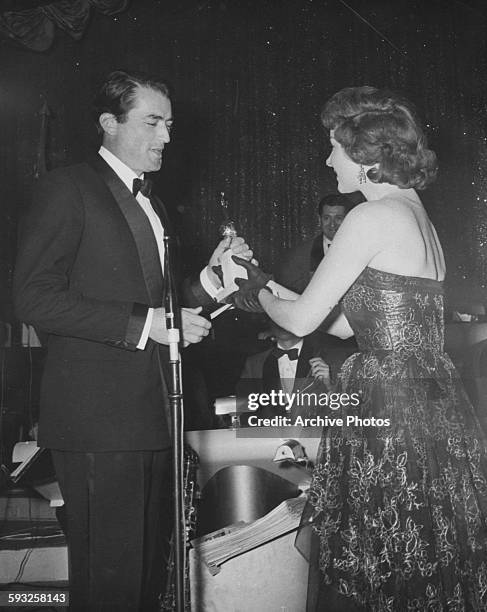 Actress Maureen O'Hara presenting the Best Actor award to Gregory Peck, at the Foreign Press Awards, or Golden Globes, at the Cocoanut Grove in...