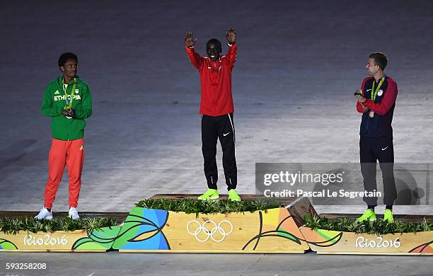 Silver medalist Feyisa Lilesa of Ethiopia, gold medalist Eliud Kipchoge of Kenya and bronze medalist Galen Rupp of the United States celebrate on the...