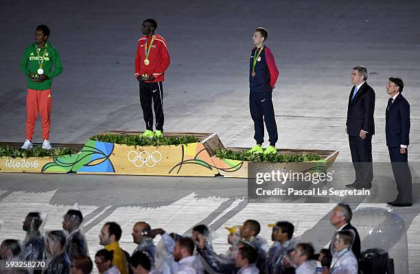 Silver medalist Feyisa Lilesa of Ethiopia, gold medalist Eliud Kipchoge of Kenya and bronze medalist Galen Rupp of the United States stand on the...