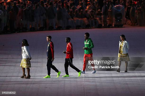 Bronze medalist Galen Rupp of the United States, gold medalist Eliud Kipchoge of Kenya and Silver medalist Feyisa Lilesa of Ethiopia leave after the...