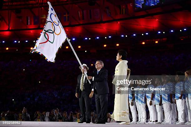 Mayor of Rio de Janeiro Eduardo Paes, IOC President Thomas Bach and Governor of Tokyo Yuriko Koike take part in the Flag Handover Ceremony during the...