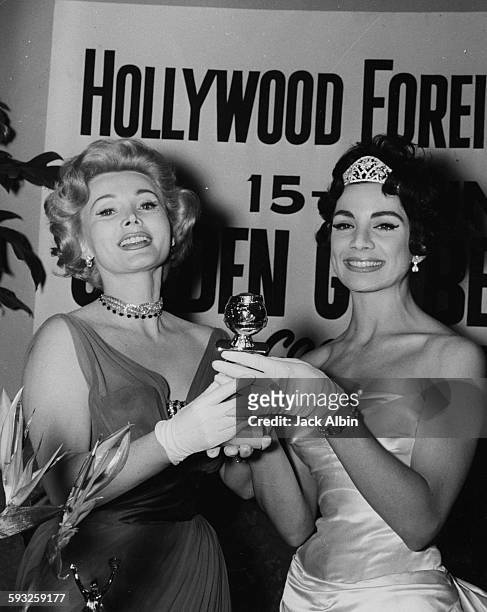 Actress Ziva Rodann presenting the Most Glamorous Actress award to Zsa Zsa Gabor at the Foreign Press Awards, or the Golden Globes, in Hollywood,...