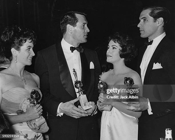 Actors Linda Cristal, Rock Hudson, Susan Kohner and John Gavin holding their awards at the Foreign Press Awards, or the Golden Globes, at the...