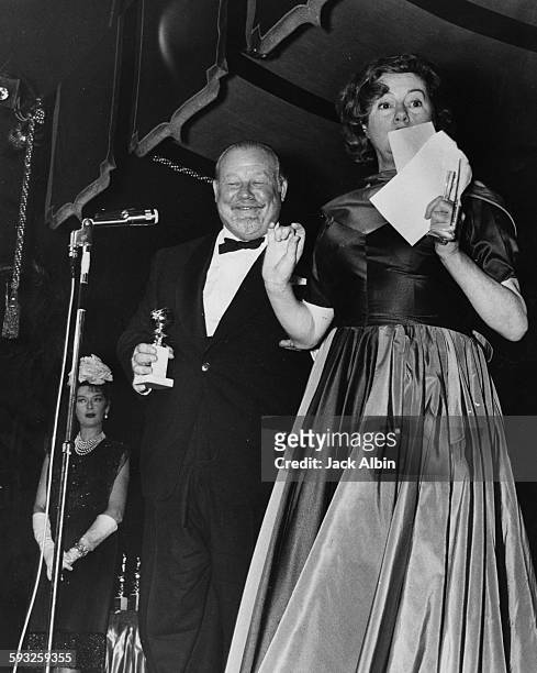 Actress Elsa Lanchester presenting the Best Supporting Actor award to Burl Ives, at the Foreign Press Awards, or the Golden Globes, 1959.