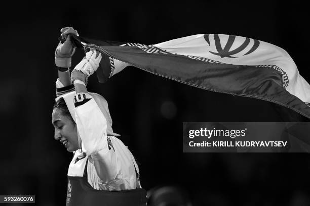 Iran's Kimia Alizadeh Zenoorin celebrates after winning against Sweden's Nikita Glasnovic in their womens taekwondo bronze medal bout in the -57kg...