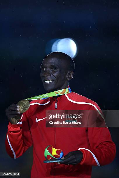 Gold medalist Eliud Kipchoge of Kenya celebrates during the medal ceremony for the Men's Marathon during the Closing Ceremony on Day 16 of the Rio...
