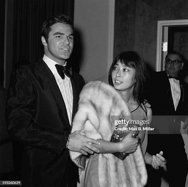 Actor Burt Reynolds and his date, actress Miko Mayama, at the Golden Globe Awards, Los Angeles, February 1971.