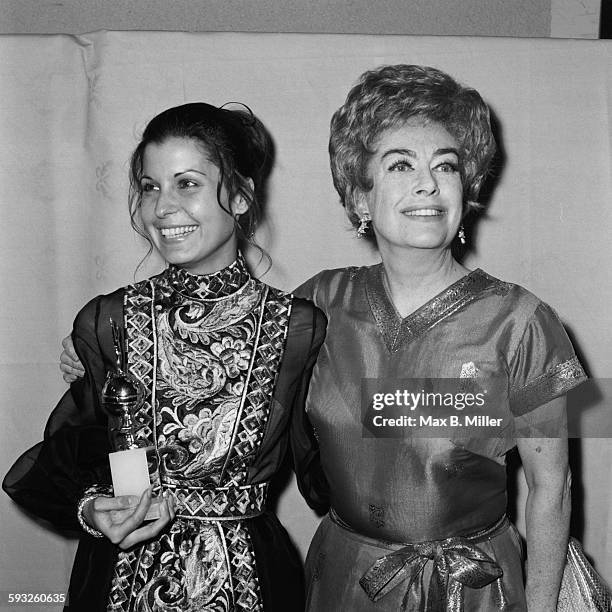 Tina Sinatra, daughter of singer and actor Frank Sinatra, holding her father's award with actress Joan Crawford at the Golden Globe Awards, Los...