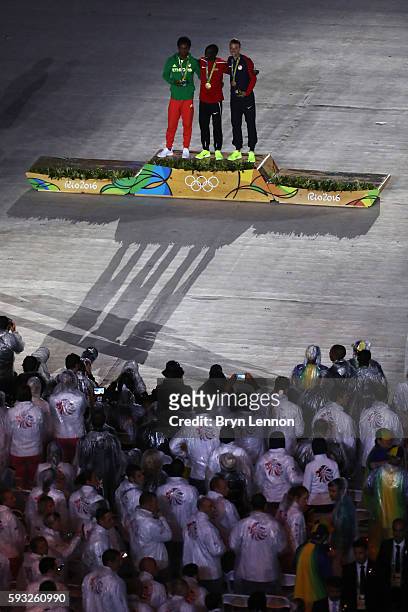 Silver medalist Feyisa Lilesa of Ethiopia, gold medalist Eliud Kipchoge of Kenya and bronze medalist Galen Rupp of the United States celebrate on the...
