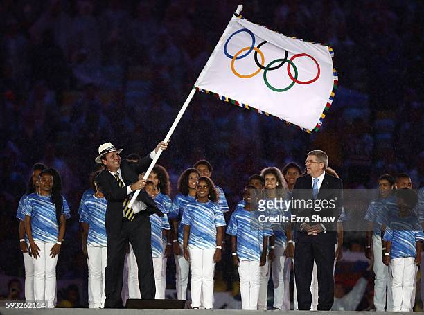 Mayor of Rio de Janeiro Eduardo Paes and IOC President Thomas Bach take part in the Flag Handover Ceremony during the Closing Ceremony on Day 16 of...
