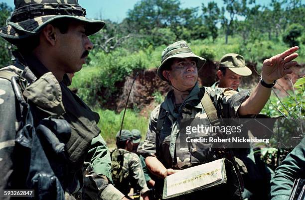 Lt Colonel Domingo Monterrosa, right, speaks with one of his company commanders, left, from El Salvador's Atlacatl Rapid Reaction Battalion as...