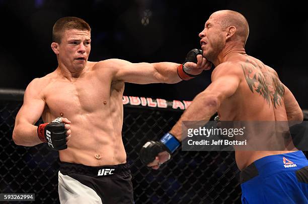 Rick Story punches Donald Cerrone in their welterweight bout during the UFC 202 event at T-Mobile Arena on August 20, 2016 in Las Vegas, Nevada.