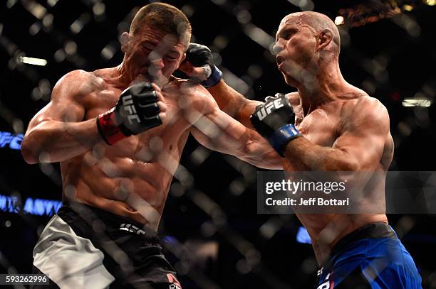 Donald Cerrone punches Rick Story in their welterweight bout during the UFC 202 event at T-Mobile Arena on August 20, 2016 in Las Vegas, Nevada.