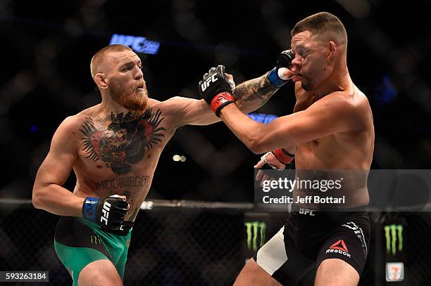 Conor McGregor of Ireland punches Nate Diaz in their welterweight bout during the UFC 202 event at T-Mobile Arena on August 20, 2016 in Las Vegas,...