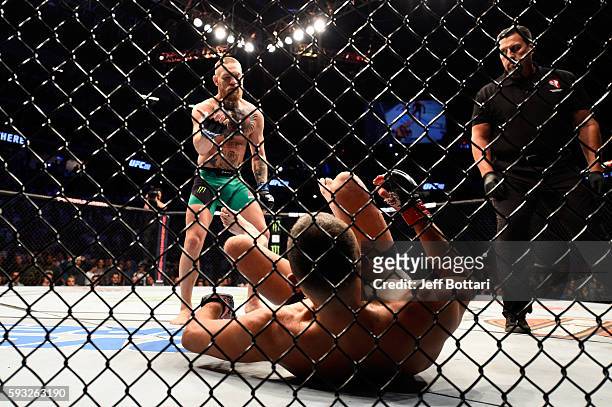 Conor McGregor of Ireland signal to Nate Diaz to stand after knocking him down in their welterweight bout during the UFC 202 event at T-Mobile Arena...