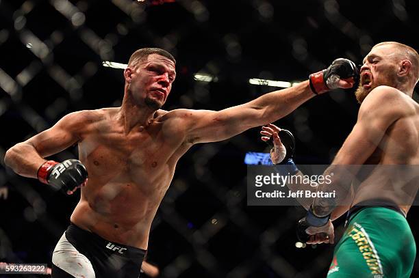 Nate Diaz punches Conor McGregor of Ireland in their welterweight bout during the UFC 202 event at T-Mobile Arena on August 20, 2016 in Las Vegas,...